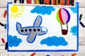 Drawing: Small blue airplane and hot air balloon