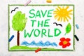 Photo of colorful drawing: Words SAVE THE WORLD on paper.