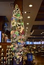 Photo of a colorful Surfboard in store with all different kinds of brand name stickers on it