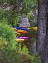 Photo of Colourful kayaks by river