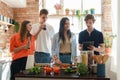 Four friends cooking home pizza and celebrating event together Royalty Free Stock Photo