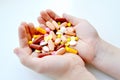 Photo of the composition of tablets, medicines, vitamins, pills in hands. Tablets in sunlight. Royalty Free Stock Photo