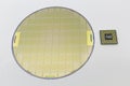 Photo of a Computer Chip CPU put near silicon wafer with microchip