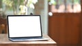 Photo of computer laptop with white blank screen putting outdoors on the modern table. Royalty Free Stock Photo