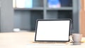 Photo of Computer laptop with white blank screen putting on white working desk with coffee cup, clipboard. Royalty Free Stock Photo