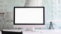 Photo of computer monitor with white blank screen putting on white working desk with wireless mouse and keyboard. Royalty Free Stock Photo