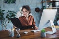 Photo of concentrated secretary sitting chair hold clipboard keyboard typing workplace business center indoors