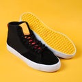 Flat style sneakers isolated on yellow background. Fashion sneakers.