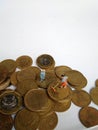 Conceptual Illustration for Money Laundry Activity, worker mini figure toy cleaning golden indonesia rupiah coin