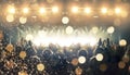 Concert hall with a wide crowd clapping in front of a stage