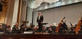 Photo director and musicians. Musical concert in the Philharmonic. Violin player. Music concert background