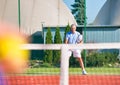 Confident mature man standing with tennis racket on court Royalty Free Stock Photo