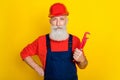 Photo of confident pensioner technician hold pipe fitter renovate old house isolated on bright color background Royalty Free Stock Photo