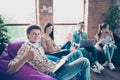 Photo of confident positive groupmates sitting dormitory preparing exams studying subjects indoors workstation workshop Royalty Free Stock Photo