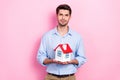 Photo of confident real estate manager realtor hold miniature building new apartments for sale cheap price offer