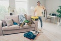 Photo of confident reliable guy prepare business trip raise thumb up wear yellow t-shirt messy room home indoors Royalty Free Stock Photo