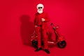 Photo of confident santa claus ready ride retro bike wear sunglass x-mas hat suit on red color background