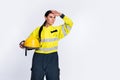 Photo of confident serious firewoman dressed uniform helmet looking far away empty space arm forehead isolated white