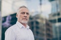 Photo of confident serious mature worker man wear formal shirt outdoors city street Royalty Free Stock Photo