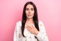 Photo of confused pretty young lady scared astonished hand touch heart bad news reaction trendy blouse isolated on pink Royalty Free Stock Photo