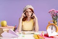 Photo of confused student girl touching her temples while doing homework