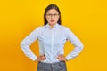 Photo of confused young business woman looking ahead on yellow background