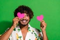 Photo of cool dreamy latin guy dressed print shirt pink heart postcard close eye looking empty space isolated green