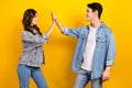 Photo of cool friendly best buddies dressed denim clapping high five isolated yellow color background Royalty Free Stock Photo