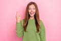 Photo of cool funky school girl dressed green sweatshirt showing hard rock sign  pink color background Royalty Free Stock Photo