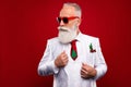 Photo of cool imposing serious old man look empty space wear three piece suit tree tie isolated on red color background Royalty Free Stock Photo