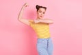 Photo of cool nice brunette lady point arm wear t-shirt pants isolated on pink background