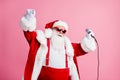 Photo of cool santa claus x-mas pop star singer sing microphone enjoy newyear concert wear sunglass suspenders headwear Royalty Free Stock Photo