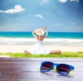 photo of cool sunglasses on the young woman on the coast background