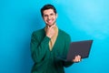 Photo of cool thoughtful man wear green cardigan arm spectacles communicating modern device isolated blue color Royalty Free Stock Photo