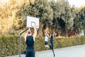 Photo with copy space of friends playing basketball outdoors