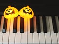 Photo with copy space of two Halloween pumpkin light decorated on piano keyboard Royalty Free Stock Photo