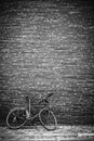 Photo with copy space of vintage bike standing against brick wall. Vertical black and white image Royalty Free Stock Photo