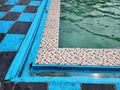 photo of the corner of a clear green and blue water swimming pool Royalty Free Stock Photo