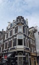 Photo of a corner house in the Netherlands, with antique windows