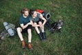 Photo of couple and a dog sitting in forest at summer with backpacks Royalty Free Stock Photo