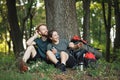 Photo of couple sitting in forest at summer with backpacks Royalty Free Stock Photo