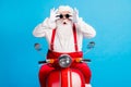 Photo of crazy astonished santa claus with beard drive modern motor bike x-mas christmas party touch gloves goggles wear