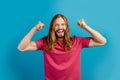 Photo of crazy delighted person raise fists achievement attainment isolated on blue color background