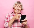 Photo of crazy ecstatic old woman use smartphone Royalty Free Stock Photo