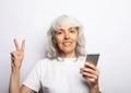 Photo of crazy ecstatic old woman use smartphone Royalty Free Stock Photo