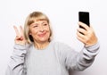 Photo of crazy ecstatic old woman use smartphone impressed social media like feedback win raise fists scream yes Royalty Free Stock Photo