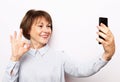 Photo of crazy ecstatic old woman use smartphone impressed social media like feedback win raise fists scream yes Royalty Free Stock Photo