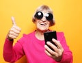 Photo of crazy ecstatic old woman use smartphone impressed social media like feedback win raise fists scream yes Royalty Free Stock Photo