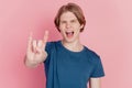 Photo of crazy excited guy happy positive smile show horns rock metal sign brutal isolated pink color background Royalty Free Stock Photo