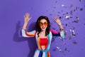 Photo of crazy excited retro lady enjoying occasion in discotheque with flying confetti isolated purple color background